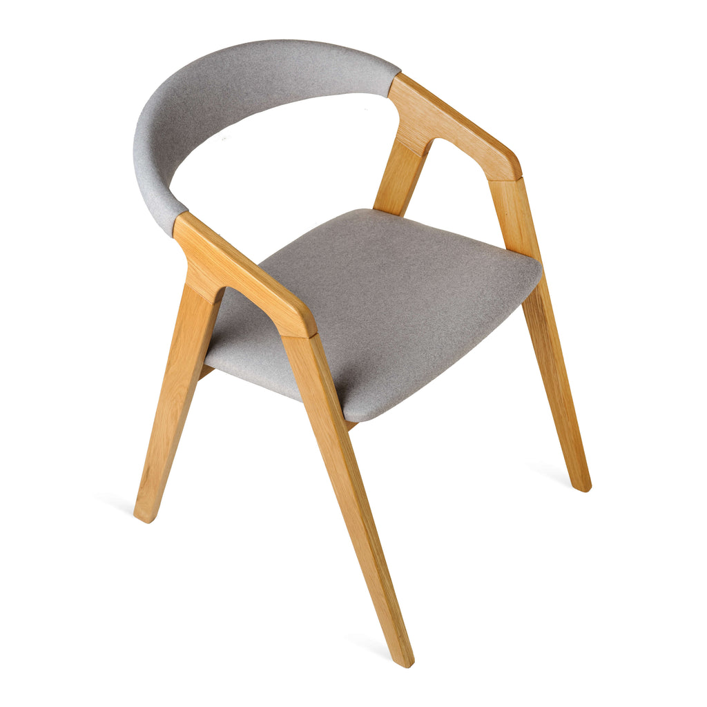 Angled perspective – Olive Ash chair showing grey fabric and warm finish