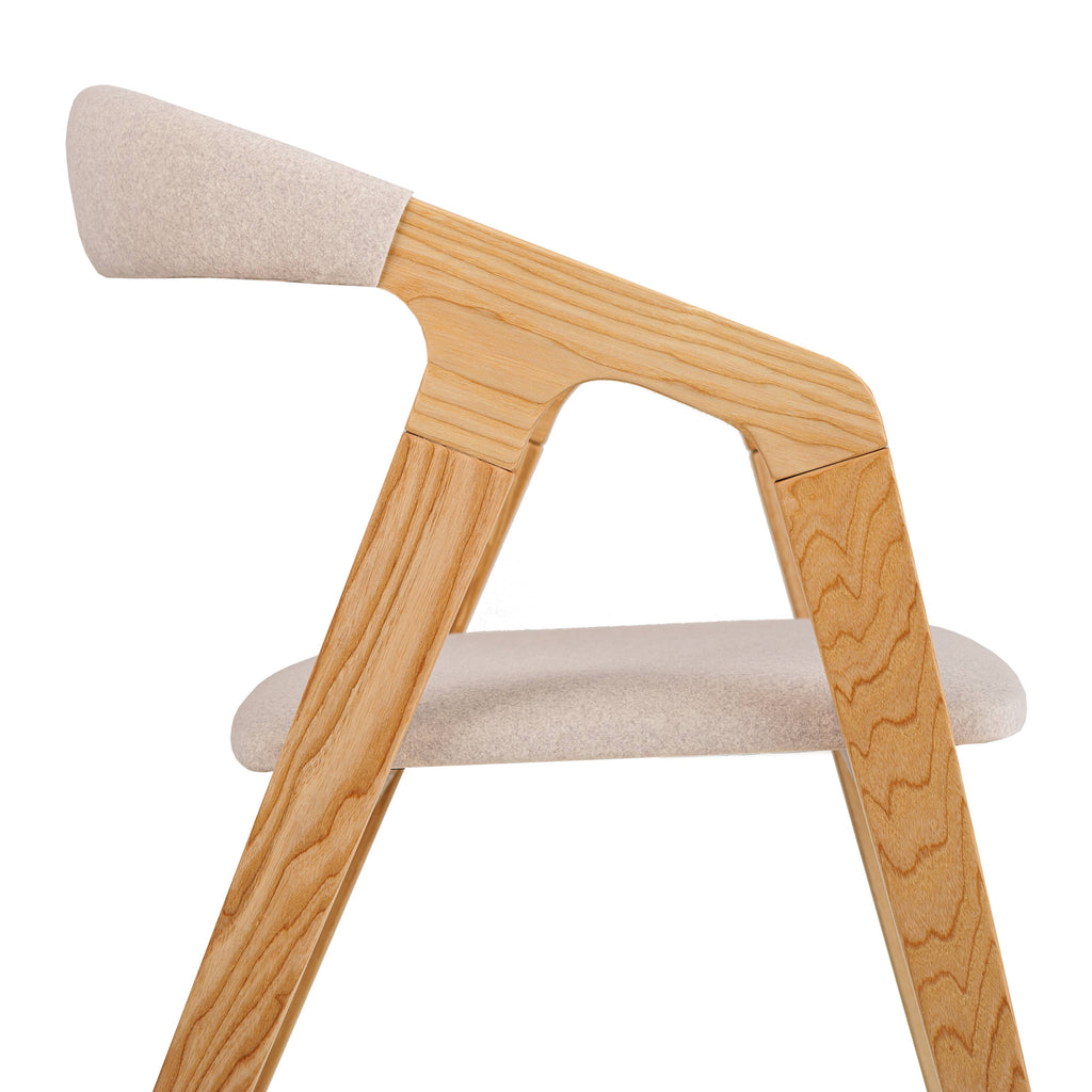 Close-up of Olive Ash Bridge Chair showing beige fabric and smooth grain texture