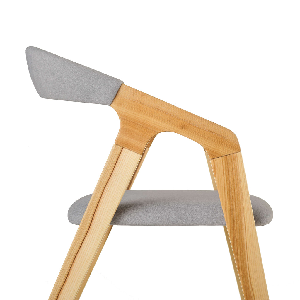 Detail shot showing curved wood edge and grey fabric texture